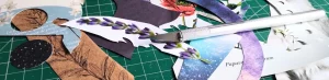 Un mat de corte, un bisturí y varios recortes de colores para hacer collage